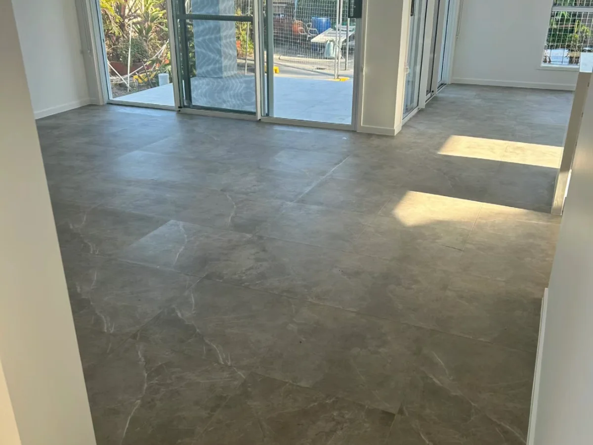 Completed floor tiling in an open-plan Canberra living space.